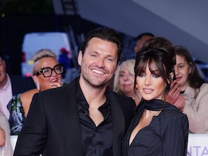 Michelle Keegan and Mark Wright smiling at red carpet event