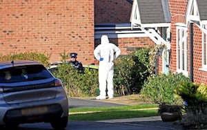 Forensic investigators at Devereux Gardens on Thursday 