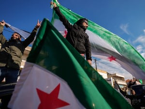 Syrians waving the national flag and celebrating