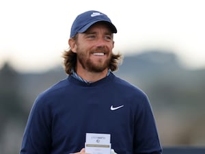 Tommy Fleetwood smiles on the golf course