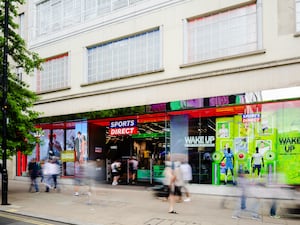 Sports Direct store on Oxford Street, London, with passers-by blurred