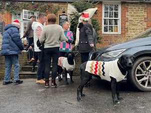 People enjoy a pre-Christmas lunch drink in the mild weather at the Holly Bush Pub, Frensham, Surrey