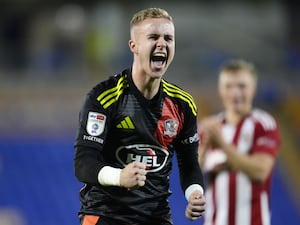 Exeter City goalkeeper Joe Whitworth celebrates in front of the fans after the Sky Bet League One match at The Croud Meadow stadium, Shrewsbury