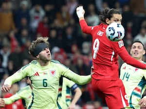 Wales defender Joe Rodon, left, applies pressure as Turkey's Enes Unal wins a header