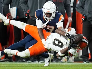 Cleveland Browns wide receiver Elijah Moore is tackled by Denver Broncos cornerback Ja’Quan McMillia