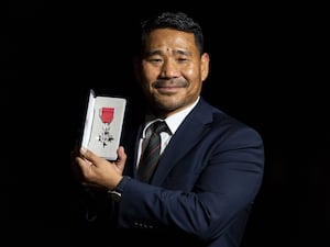 Hari Budha Magar holding his MBE medal