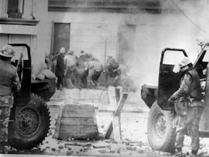 Soldiers take cover behind their sandbagged armoured cars in Londonderry on Bloody Sunday (PA)