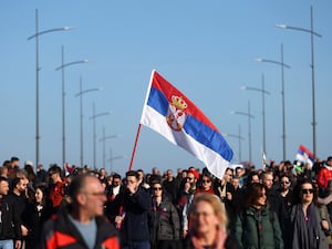 Protesters walk across a bridge