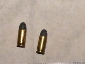 Three bullets sit on a sheet