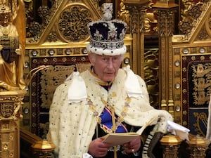 The King wearing the Imperial State Crown and his regal robes as he reads the King’s Speech during the State Opening of Parliament