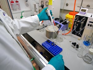 Staff work inside the AstraZeneca Laboratory in Macclesfield, England.