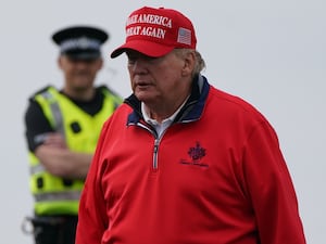 Donald Trump in a red hat and jacket