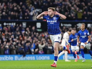 Liam Delap puts his hands to his ears in celebration