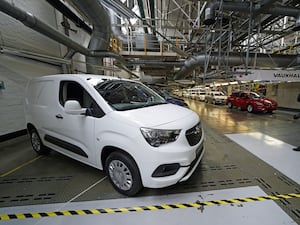 A photographer takes a picture of a new electric van at Vauxhall’s plant in Ellesmere Port, Cheshire