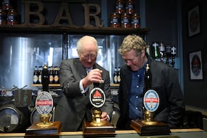 King Charles III pulls a pint alongside Tower Brewery owner John Mills, during a visit to Tower Brewery in Burton Upon Trent. Photo: Jaimi Joy/PA Wire