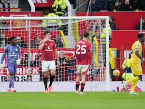 Manchester United’s Harry Maguire (centre left) stands dejected after the team concede a goal to Crystal Palace