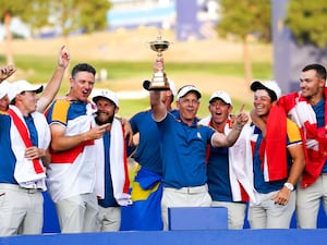 Luke Donald lifts the Ryder Cup surrounded by his European team