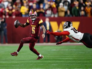 Washington Commanders quarterback Jayden Daniels scrambles away from Atlanta Falcons offensive tackle Brandon Parker