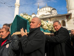 Relatives carry a coffin during the funeral of three members of the Inal family, who died in a fire that broke out at the Kartalkaya ski resort