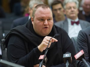 Kim Dotcom points while speaking in court