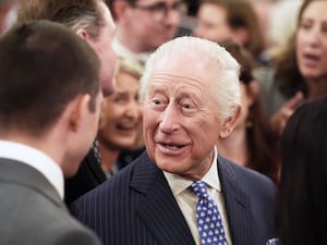 The King chats to guests at a Palace reception