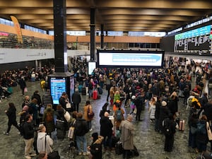 Dozens of passengers on station concourse