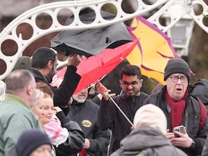 People struggle with their umbrellas as the wind picks up in Dublin’s city centre, as snow, rain and wind warnings are in force and are expected to cause travel issues on New Year’s Eve