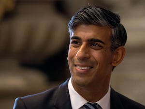 A headshot of former prime minister Rishi Sunak smiling