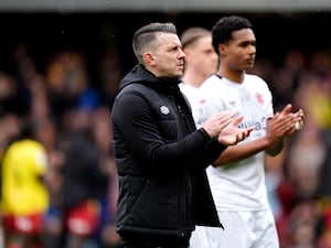 Luton manager Matt Bloomfield applauds the travelling fans after a 2-0 defeat at Watford