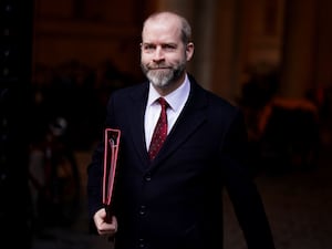 Jonathan Reynolds carrying a business folder