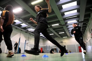 Year 11 pupils in a PE lesson in the school's sports hall