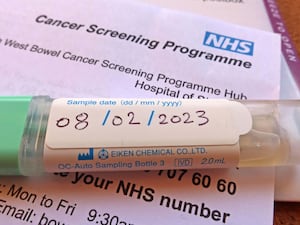 A sample pot on an NHS cancer screening programme letter