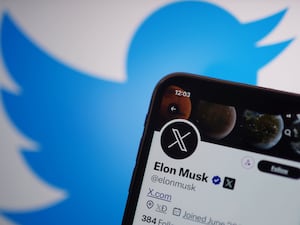 A phone displaying the Twitter account for Elon Musk