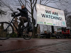 Activists put up a billboard outside the International Court of Justice, in The Hague, Netherlands