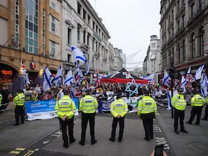 Police watch a counter-protest near Piccadilly Circus during a Palestine Solidarity Campaign rally in central London