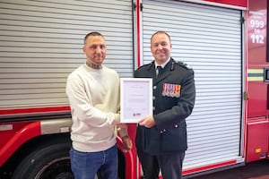 Tom Alexander receives his Certificate of Meritorious Action from Assistant Chief Fire Officer Richard Stanton. Photo: West Midlands Fire Service