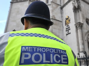 A Metropolitan Police officer outside the Royal Courts of Justice in central London