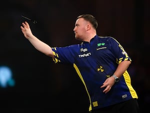 Luke Littler throws a dart