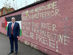 DUP leader Gavin Robinson by a graffitied wall