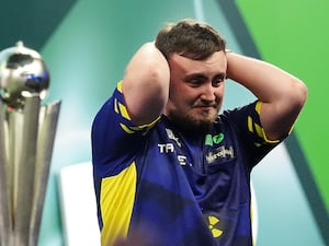 Luke Littler puts his hands on his head in disbelief after winning the World Championship