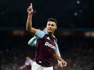 Aston Villa’s Ollie Watkins points his finger in the air as he celebrates a goal