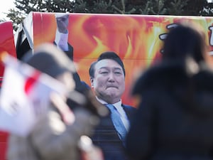 A picture of impeached South Korean President Yoon Suk Yeol is seen on the vehicle during a rally to oppose his impeachment