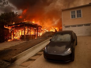 The Palisades Fire burns a structure in the Pacific Palisades neighborhood of Los Angeles