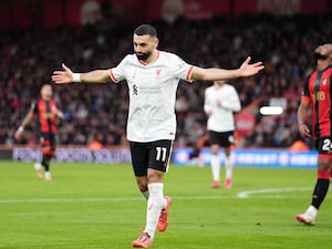 Mohamed Salah celebrates with his arms outstretched