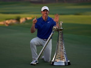 Rory McIlroy of Northern Ireland poses with the DP World Tour Championship trophy and the Race to Dubai trophy