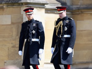 Harry and William in uniform walking to church side by side on Harry's wedding day