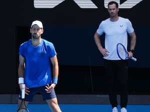 Andy Murray, right, watches Novak Djokovic practice