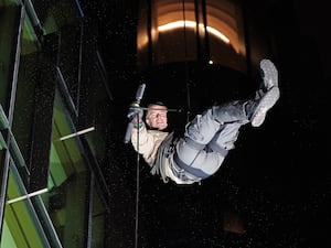 Bear Grylls abseiling down the side of the Odeon