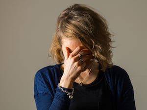 A woman with her head in her hands