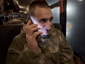 A Russian soldier speaks on the phone